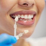 Dentist, cleaning and dental procedure for toothache in clinic, health and treatment for mouth. Teeth whitening, face and person with torque wrench machine, orthodontics and oral care for veneers.