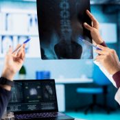 Physician meeting with a patient to discuss medical test results in a cabinet, using advanced diagnostic tools to interpret x ray scans, demonstrating a professional healthcare approach.